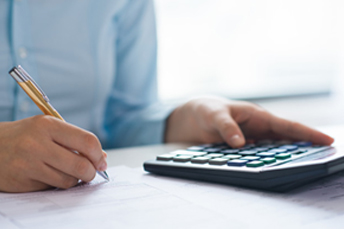 doing accounting with calculator and pen